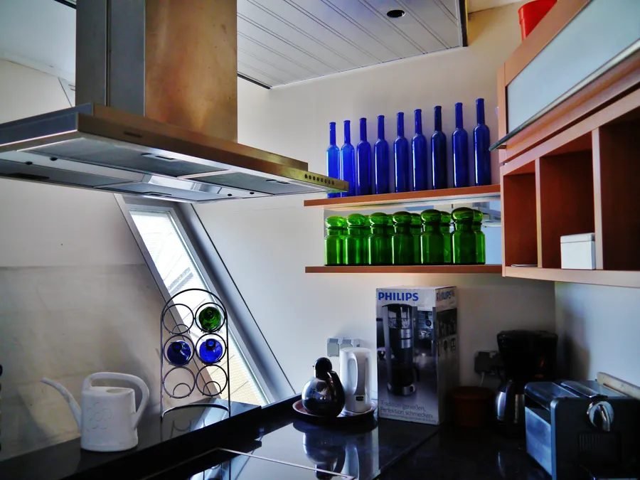 Kitchen inside the Kijk-Kubus museum-house, Rotterdam, showing the tilted window and angled walls