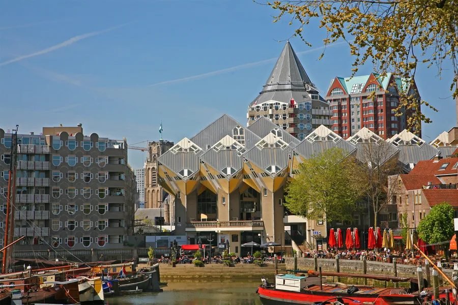 Cube Houses seen across the water from the Old Harbour (Oude Haven), Rotterdam, with historic boats moored in front