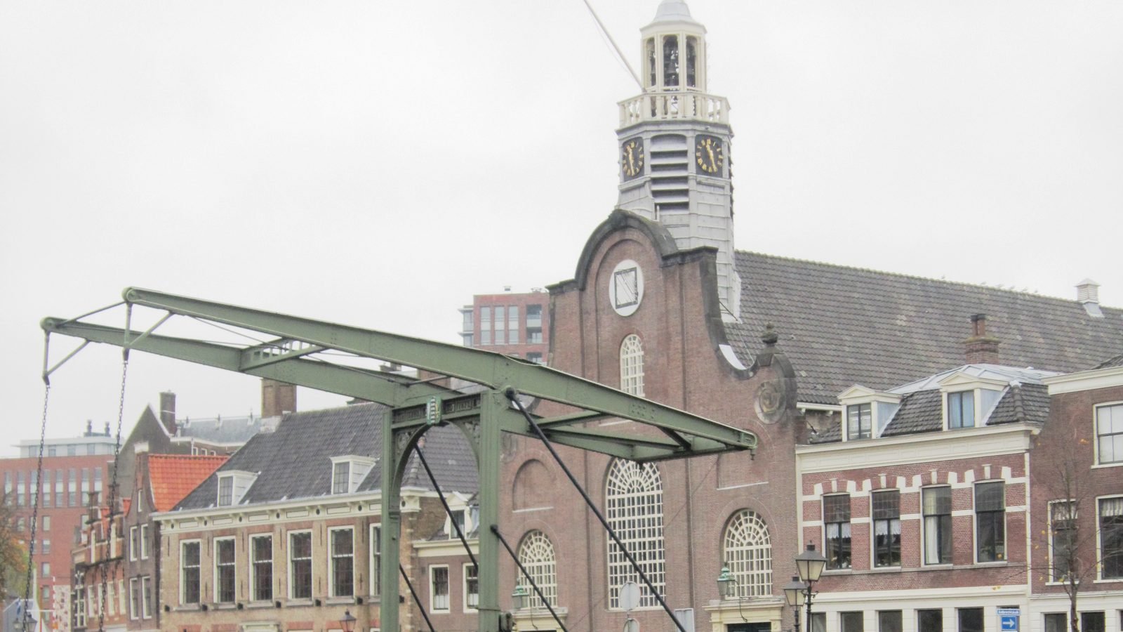 The Oude of Pelgrimvaderskerk church tower and the Piet Heynsbrug drawbridge over the Aelbrechtskolk canal in historic Delfshaven, Rotterdam